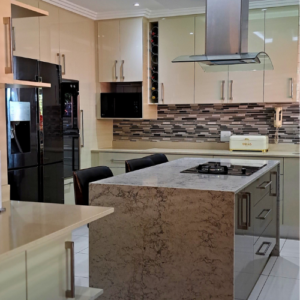 Modern kitchen with a big center island in the PMB area.